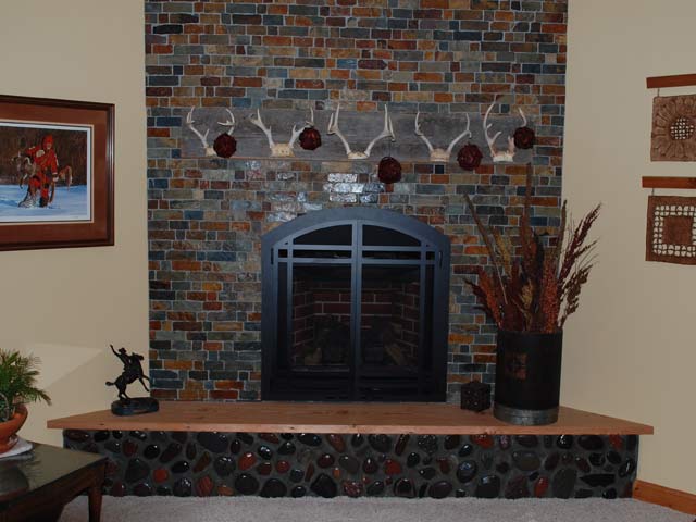 Fireplace and hearth with reds, browns and oranges