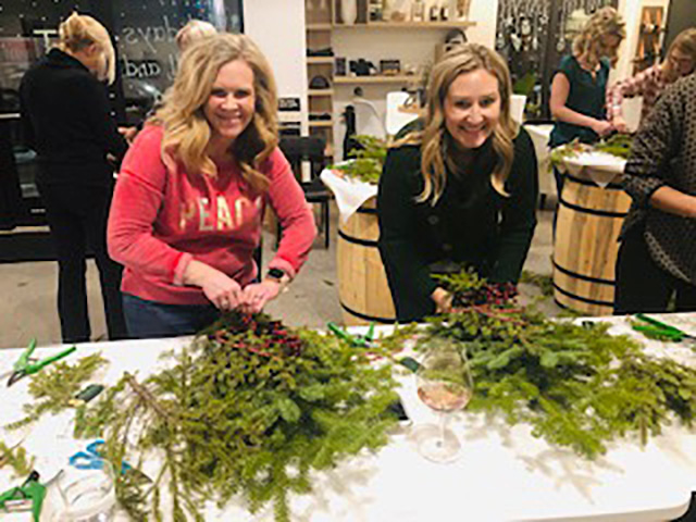 Ladies making a holiday front door spray